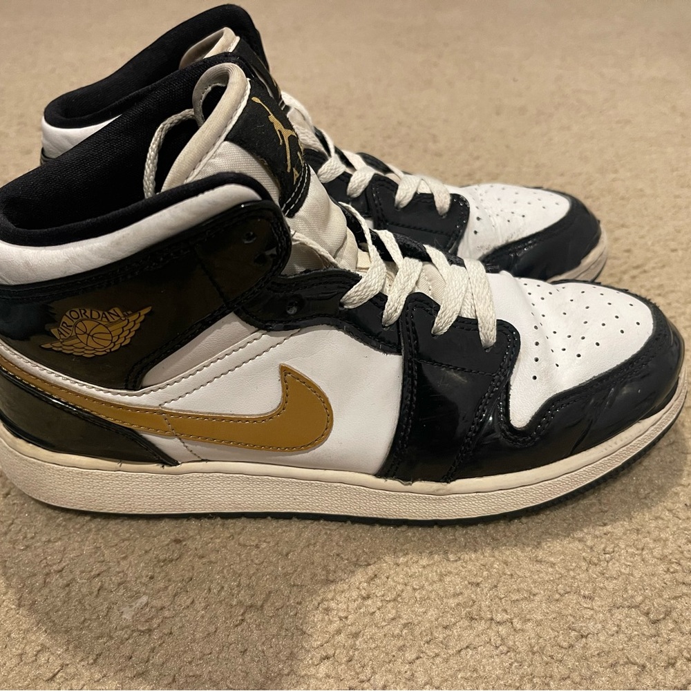 Nike Air Jordan Black, White, and Gold High Tops